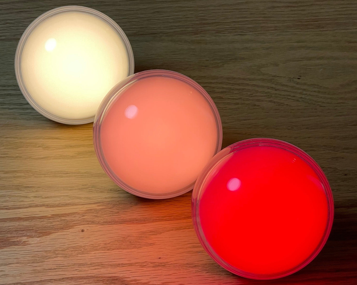 3 somni sleep night lights in different colours. From left to right the first one is warm white, the next is pink and the thurd one is red.